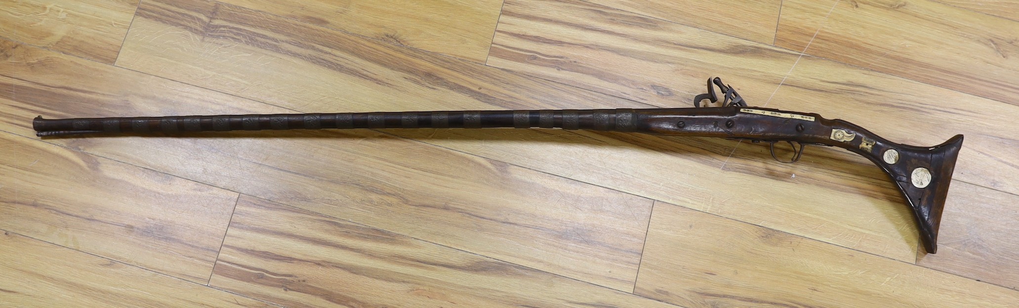 An Eastern antique flintlock rifle - 152cm long
